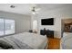 Spacious main bedroom features wood floors, a ceiling fan, large TV, and ensuite access at 6404 Extreme Shear Ave # 103, Henderson, NV 89011