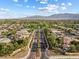 Stunning aerial view of a well-maintained neighborhood with tree-lined streets and mountain views in the distance at 6895 Kelp Ledge Ct, Las Vegas, NV 89131