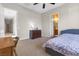 Bedroom with large window, desk, dresser and an open doorway leading to another room at 6895 Kelp Ledge Ct, Las Vegas, NV 89131