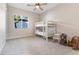 Bedroom with a bunk bed, carpet, window, ceiling fan and decorative rocking horses at 6895 Kelp Ledge Ct, Las Vegas, NV 89131