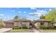 Inviting single-story home with a stone-accented facade, manicured landscaping, and a spacious three-car garage at 6895 Kelp Ledge Ct, Las Vegas, NV 89131