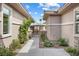 Landscaped home entrance with a walkway, decorative plants, and gated courtyard at 6895 Kelp Ledge Ct, Las Vegas, NV 89131