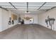 Spacious garage featuring a painted floor, storage, and utility connections at 6895 Kelp Ledge Ct, Las Vegas, NV 89131