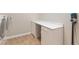 Convenient laundry area featuring a built-in desk and storage, adjacent to modern laundry machines at 6895 Kelp Ledge Ct, Las Vegas, NV 89131