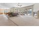 Expansive living room with fireplace, large windows, neutral tones and seamless transition to outdoor space at 6895 Kelp Ledge Ct, Las Vegas, NV 89131
