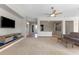 Open-concept living room boasts natural light, neutral tones, and a ceiling fan creating a relaxing atmosphere at 6895 Kelp Ledge Ct, Las Vegas, NV 89131