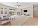 Spacious living room with a fireplace, fan, and access to the backyard at 6895 Kelp Ledge Ct, Las Vegas, NV 89131