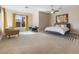 Spacious main bedroom features natural light, a ceiling fan, and comfortable seating at 6895 Kelp Ledge Ct, Las Vegas, NV 89131
