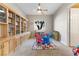 Bright playroom featuring built-in bookshelves, a colorful rug, and a table at 6895 Kelp Ledge Ct, Las Vegas, NV 89131