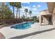 Backyard pool with tropical landscaping, privacy fence, and covered patio at 6895 Kelp Ledge Ct, Las Vegas, NV 89131