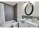 A bathroom features modern design and finishes, including dark tiling in the tub area at 7030 Burcot Ave # D106, Las Vegas, NV 89156