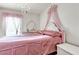 The pink bedroom is set up for a and includes a chandelier at 7030 Burcot Ave # D106, Las Vegas, NV 89156