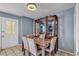 Dining area with wooden table, upholstered chairs, display cabinet, and tiled flooring at 7030 Burcot Ave # D106, Las Vegas, NV 89156