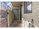 Exterior entrance featuring a security gate and door with an exterior light fixture at 7030 Burcot Ave # D106, Las Vegas, NV 89156