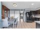 Eat-in kitchen with dark cabinets, tile flooring, stainless appliances, and dining room view at 7030 Burcot Ave # D106, Las Vegas, NV 89156