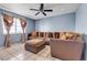 A comfortable living room boasts a ceiling fan and a large sofa with many pillows at 7030 Burcot Ave # D106, Las Vegas, NV 89156