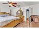 The main bedroom features a four-poster bed frame and matching dresser and ceiling fan at 7030 Burcot Ave # D106, Las Vegas, NV 89156