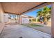 Relaxing covered patio area with a shed and mature landscaping offers a serene outdoor living space at 7033 Red Tide Dr, Las Vegas, NV 89131
