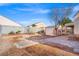 Backyard featuring a small shed, brick accents, and a rock and mulch garden at 7033 Red Tide Dr, Las Vegas, NV 89131