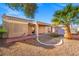 View of the backyard featuring a covered patio, desert landscaping, and a partial brick border at 7033 Red Tide Dr, Las Vegas, NV 89131