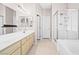 Bright bathroom with dual sinks, tub and a glass-enclosed shower, all with modern fixtures at 7033 Red Tide Dr, Las Vegas, NV 89131