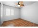 Bedroom with neutral paint, wood floors, a ceiling fan, and a window with natural light at 7033 Red Tide Dr, Las Vegas, NV 89131