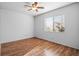 Bedroom with neutral paint, wood floors, a ceiling fan, and a window with natural light at 7033 Red Tide Dr, Las Vegas, NV 89131