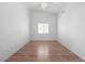 An empty bedroom featuring hard wood floors and a window with blinds at 7033 Red Tide Dr, Las Vegas, NV 89131