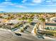 View of a gated community entrance featuring desert landscaping and palm trees at 7033 Red Tide Dr, Las Vegas, NV 89131
