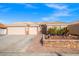 Inviting home with a three-car garage, decorative iron gate, and xeriscaping for low maintenance at 7033 Red Tide Dr, Las Vegas, NV 89131