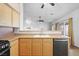 Bright kitchen with wood cabinets, stainless appliances, and an open layout connecting to the living area at 7033 Red Tide Dr, Las Vegas, NV 89131
