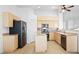 Functional kitchen featuring natural wood cabinets, stainless steel appliances and a granite countertop island at 7033 Red Tide Dr, Las Vegas, NV 89131