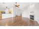 Spacious living room with hardwood floors, a fireplace, and an open layout connected to the kitchen at 7033 Red Tide Dr, Las Vegas, NV 89131