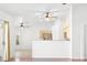 Bright, open-concept living room featuring modern ceiling fans and seamless transition into the kitchen area at 7033 Red Tide Dr, Las Vegas, NV 89131