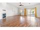 Bright living room featuring hardwood floors, a fireplace, and sliding glass doors to the backyard at 7033 Red Tide Dr, Las Vegas, NV 89131