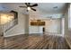 Open-concept living space with kitchen view and ceiling fans at 7322 Fools Gold St # 102, Las Vegas, NV 89149