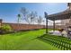 Backyard featuring artificial grass, a covered patio, and a built-in basketball hoop at 7900 Eastern Elk St, Las Vegas, NV 89149
