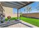 Backyard featuring artificial grass, a covered patio, and a built-in basketball hoop at 7900 Eastern Elk St, Las Vegas, NV 89149