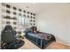 Bedroom with plaid accent wall, desk, and sporty basketball-themed bedding at 7900 Eastern Elk St, Las Vegas, NV 89149