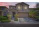 Charming two-story home featuring desert landscaping, covered entry, and attached two-car garage at 7900 Eastern Elk St, Las Vegas, NV 89149