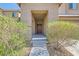 Inviting covered entryway with lush landscaping leading to the front door at 7900 Eastern Elk St, Las Vegas, NV 89149