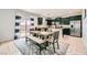 Bright kitchen and dining area featuring granite counters, stainless steel appliances, and sliding glass door to yard at 7900 Eastern Elk St, Las Vegas, NV 89149