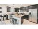 Modern kitchen featuring dark cabinets, granite countertops, a stainless steel refrigerator, and center island at 7900 Eastern Elk St, Las Vegas, NV 89149