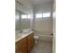 Bathroom with double vanity, shower over tub, and tile flooring at 7977 Blue Brook Dr, Las Vegas, NV 89147