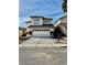 Two-story stucco house with a two car garage and stone accents on the front at 7977 Blue Brook Dr, Las Vegas, NV 89147