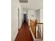 Upstairs hallway with wood floors and wooden railing at 7977 Blue Brook Dr, Las Vegas, NV 89147