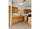 Kitchen with tile flooring, oak cabinets, and white appliances at 7977 Blue Brook Dr, Las Vegas, NV 89147