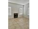 Living room with tile flooring, fireplace, and two windows at 7977 Blue Brook Dr, Las Vegas, NV 89147