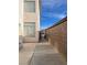 A view of the side yard showing walkway to a gated backyard and perimeter wall for privacy at 7977 Blue Brook Dr, Las Vegas, NV 89147