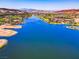 Gorgeous aerial view of a lake community surrounded by desert landscape and mountains in the distance at 8 Reflection Cove Dr, Henderson, NV 89011